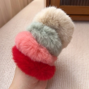 Set of four colorful plush faux fur hair scrunchies in beige, pink, red, and green