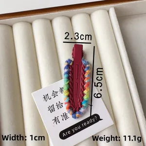 Detailed view of knitted hair clip showing dimensions 6.5cm length and 11.1g weight