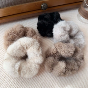 Detail showing five assorted faux mink fur scrunchies in neutral autumn colors