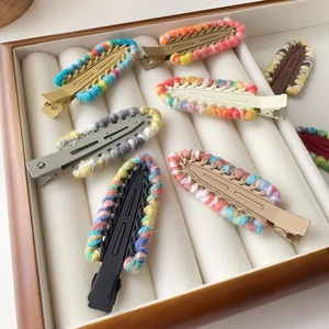 Detail of colorful knitted woolen edge hairpins with woven texture in a wooden box
