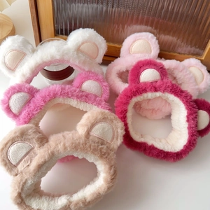 Macro detail of fluffy plush bear ear headbands in various colors on white surface