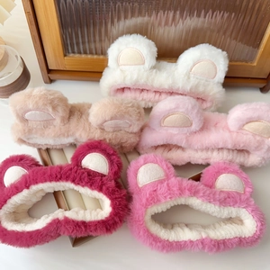 Detail view of five assorted colors of plush bear ear headbands for face washing