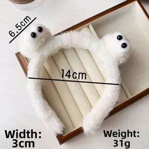 Detail showing plush headband dimensions 14cm diameter with cute cartoon eyes design