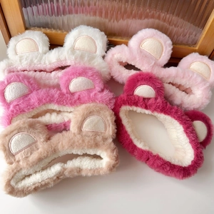 Close-up of soft plush bear ear headbands in multiple colors for face washing