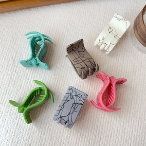 Set of six matte finish hair claws with marble texture in various pastel colors