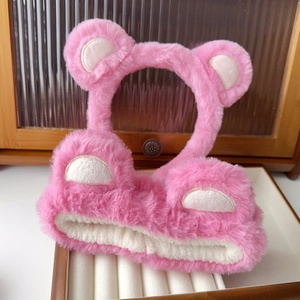 Close-up of pink plush bear ear headband with fluffy texture for washing face