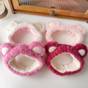 Detail of four colorful plush bear ear headbands in white, pink, rose and dark red colors