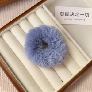 Close-up of soft lavender plush faux fur scrunchie in a premium wooden jewelry display box
