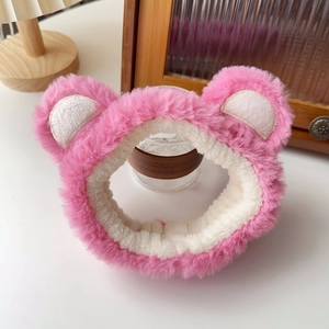 Close-up of pink fluffy plush bear ear headband for face washing with soft textures
