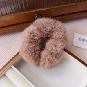Detail of plush faux mink fur scrunchie in dusty pink with soft textured pile