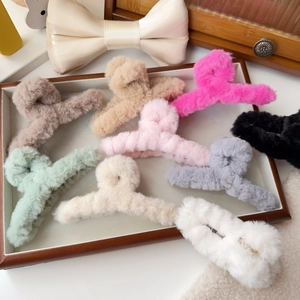 Detailed view of eight assorted plush faux fur hair claw clips in various elegant colors