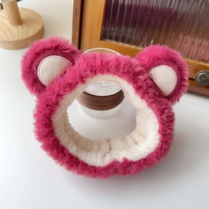 Detail of soft plush strawberry bear headband in rose red for facial washing and makeup