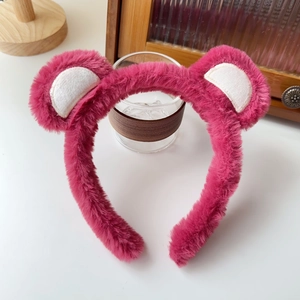 Close-up of pink plush bear ear headband with soft fluffy texture for face washing