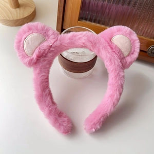 Close-up of pink plush hairband showing soft faux fur texture and cute bear ears