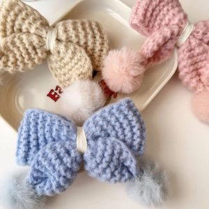 Détail de pinces à cheveux en maille avec pompons doux aux couleurs de macaron