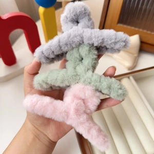 Three-piece plush hair claw clips in soft grey, green, and pink colors for winter hair styling