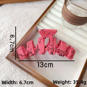 Detailed size parameters of pink matte shark hair clip with black ink splatter patterns