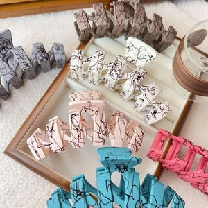 Matte finish oversized wave shark hair claws with marble splash patterns in diverse colors