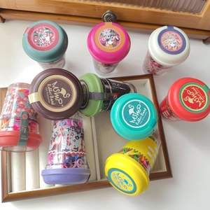 Detailed view of colorful elastic hair bands in a portable transparent cup packaging
