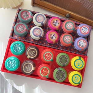 Candy colored hair ties set in small jars for girls including many elastic rubber bands