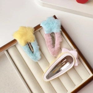 Vue détaillée des barrettes étoiles en peluche montrant la doublure et le clip en métal