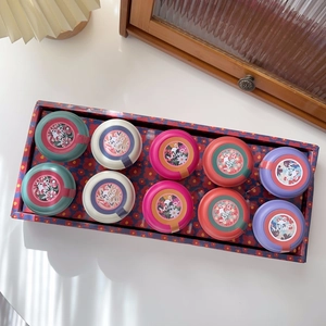 Detailed top view of MSMP herbal tea gift set with colorful tins and floral patterns