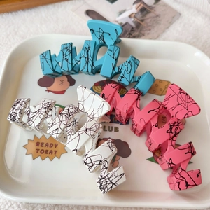 Matte wave hair claws in blue white and pink with stylish black ink graffiti patterns