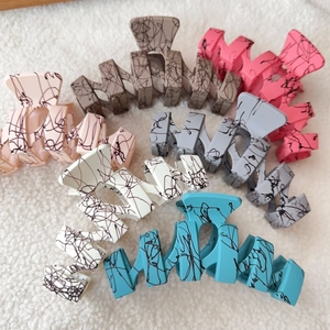 Matte wave-shaped oversized shark hair clips in six assorted colors with doodle patterns