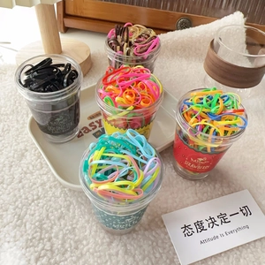 Creative bottled candy-colored elastic hair ties in transparent cups with beverage labels