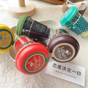 Close-up of colorful elastic hair bands inside a creative mini coffee cup container