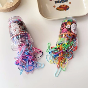 Colorful elastic rubber hair bands in transparent jars with macaron and vibrant mixed colors