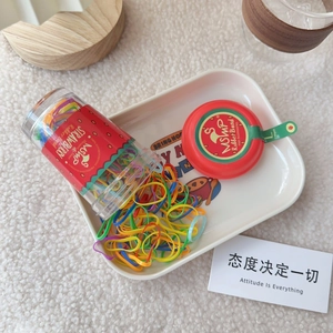 Clear jar with strawberry label containing 130 pieces of colorful elastic hair bands