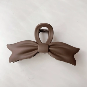 Minimalist large brown matte ribbon bow hair claw clip for a sophisticated hair styling look