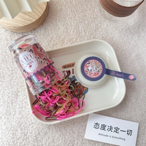 Detail of candy color elastic hair bands in a transparent container for girls