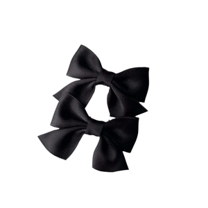 Set of two black grosgrain ribbon bow hair clips with classic ribbed texture on white background
