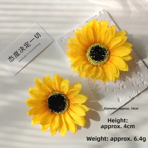 Detail view of sunflower hair clip made of silk petals with 10cm diameter measurement