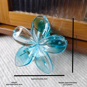 Detail view of blue translucent plumeria hair claw clip with size measurements