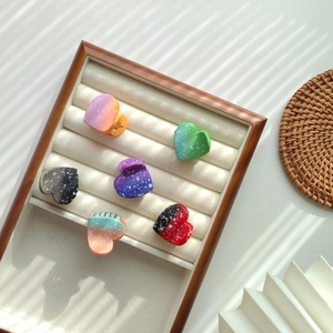 6-piece set of heart-shaped hair claws with colorful gradient and splatter patterns