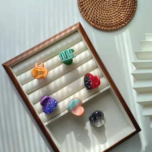Colorful polka dot and gradient heart hair claws set in a wooden jewelry organizer tray