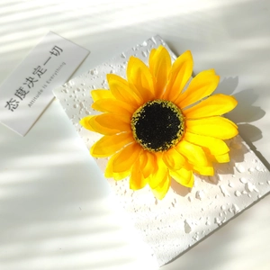 Detailed close-up of a realistic artificial sunflower head with vivid yellow petals