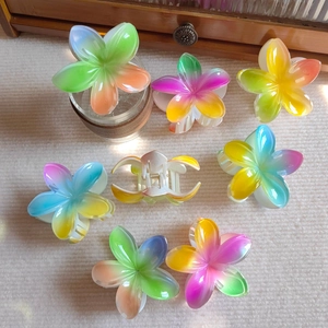 Colorful plumeria flower hair claws in resin gradient colors for summer vacation