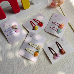 Close-up of cute cartoon hair clips set with rabbit, bear, and flower patterns