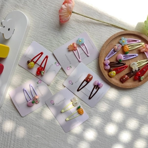 Detail of colorful cartoon bunny and flower hair clips for girls on display cards