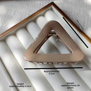 Detail view of khaki triangle hair claw clip with measurements 7.7cm x 4.3cm and spring