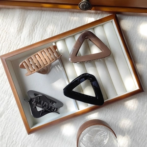 Selection of triangle and rectangular hair claws in matte and glossy neutral colors