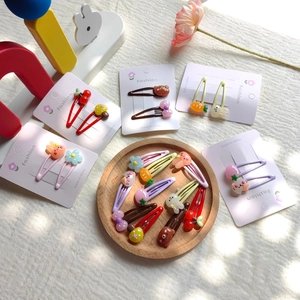 Charming kids cartoon hair clips set with rabbit and flower resin motifs on white card