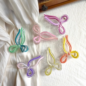 Detail showing various colorful butterfly hair claws in acrylic with metal springs