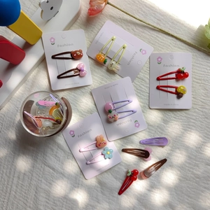Detail of cute bear and bunny resin charms on macaron metal hair clips for little girls