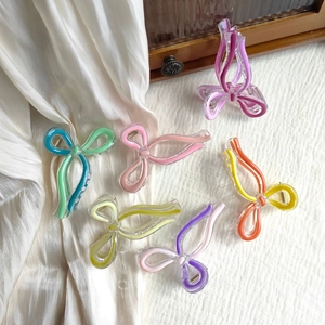 Set of 6 colorful butterfly hair claws in translucent resin on elegant silk background