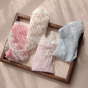 Close-up of lace trim texture and pleated fabric on four-color women's briefs set